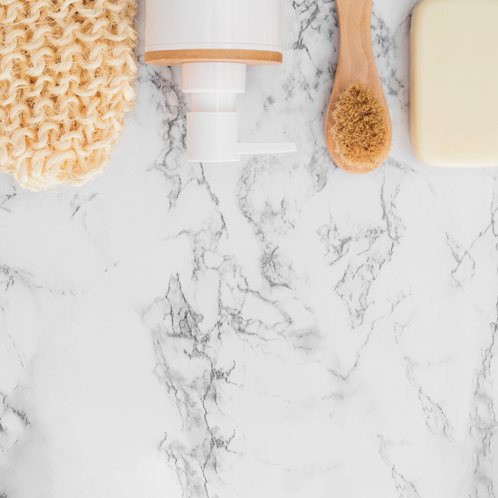 High Angle View Scrub Glove Cosmetic Bottle Soap Brush Surface Marble Countertop