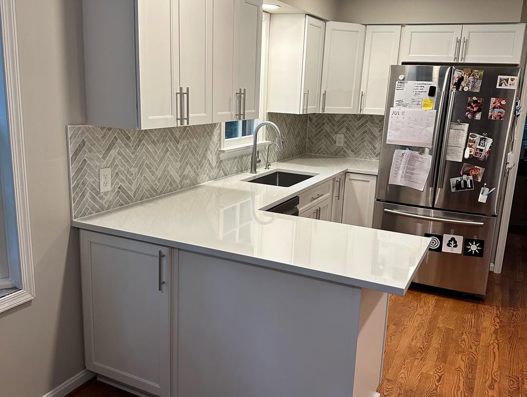 White kitchen with quartz peninsula and seating overhang fabricated and installed by Prime Countertops